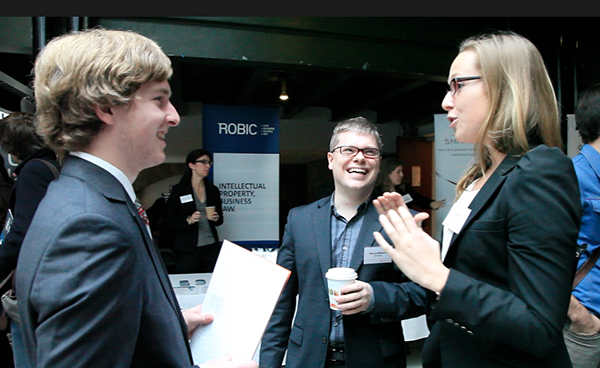 Anaïs Lacroix et Pierre-Étienne Morand de Norton Rose discutent avec un étudiant.